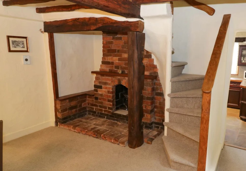 Red brick cottage facade with clay tile roof in Bentley Heath